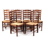 A set of North Country style stained beech ladderback dining chairs with drop-in rush seats (6).