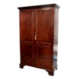 A 19th century French style mahogany armoire with moulded cornice above twin panelled doors, above a