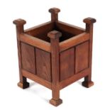 An Arts & Crafts style oak Gothic influence planter, 24cms wide.