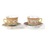 A pair of Chinese famille rose cups and saucers decorated with characters on a yellow ground, six