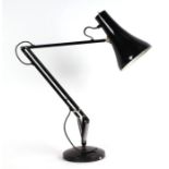 A Herbert Terry style Anglepoise lamp on a circular base.