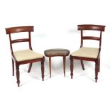 A pair of William IV mahogany dining chairs with drop-in seats, on ring turned front legs;