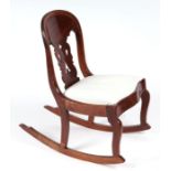 A 19th century mahogany child's rocking chair with pierce splat and upholstered seat