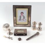 Two silver pepper grinders, a silver photo frame, a silver babies rattle, silver mounted dressing