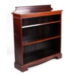 An Edwardian mahogany open bookcase with two adjustable shelves, on bracket feet, 98cms wide.
