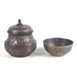 An Islamic damascene pot and cover with copper and white metal overlay, 12cms high; together with