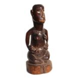 An African tribal art Bakongo funerary figure in the form of a female body with male head, 36cms