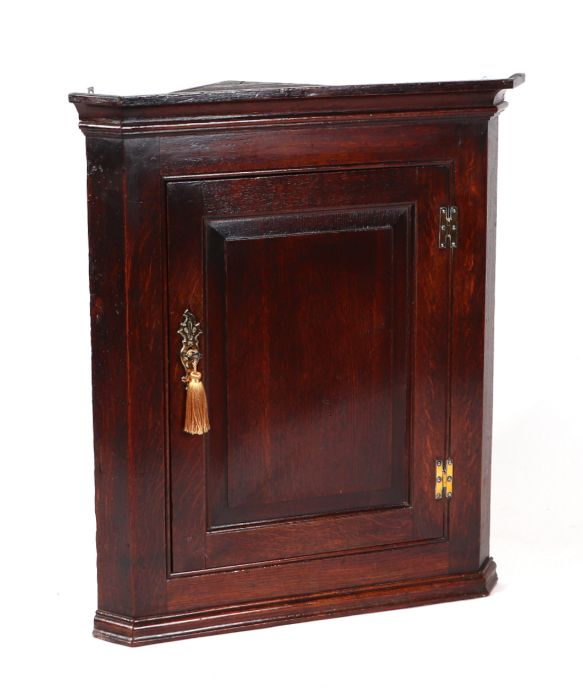 A George III oak hanging corner cupboard with single panelled door enclosing a shelved interior, - Image 2 of 2