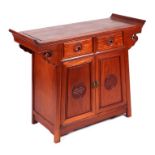 A Chinese hardwood altar table with an arrangement of two drawers above two panelled doors with