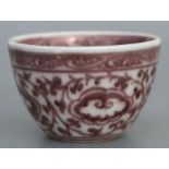 A Chinese manganese tea bowl decorated with scrolling foliage, 8cms diameter.