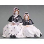 A Royal Worcester figural group depicting two young ladies reading, designed by Frederick M Gertner,