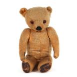 A vintage plush teddy bear with long limbs, approx 40cms high.