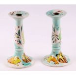 A pair of Roger Mitchell (1947-2018) pottery candlesticks decorated with stylised animals and