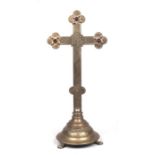 A large brass altar crucifix set with three red glass cabochons, 60cms high.