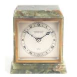 An Elliott mantle clock in a figured green onyx case, the silvered dial with Roman numerals, 15cms