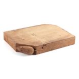 A Robert Mouseman Thompson style oak cheese board, 28cms wide.