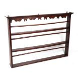 A 19th century wall hanging three-shelf plate rack, 130cms wide.