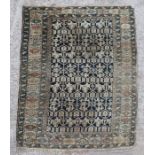 A Persian rug with repeating geometric motifs on a blue ground within a multi border, 117 by