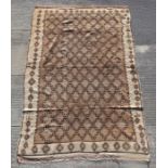 A Moroccan Berber style Beni Ouarain Middle Atlas woollen hand knotted rug with repeat design on a