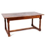 A 19th century French fruitwood refectory kitchen table, the rectangular top on ring turned supports