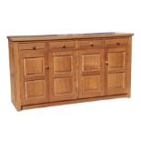 A Monk Man Arts & Crafts style oak sideboard with four drawers above two pairs of panelled doors, on