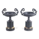 A pair of Grand Tour style bronzed two-handled urns on marble plinths, 20cms high (2).