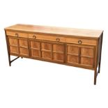 A mid century teak sideboard with an arrangement of three frieze drawers above three fielded