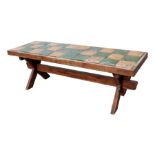 A French rustic farmhouse tile top table on an 'X' frame joined by a stretcher, 202cms wide.