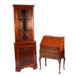 A George III style mahogany corner cabinet on cupboard, the astragal glazed panelled door