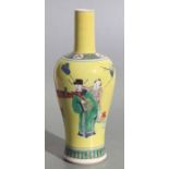 A Chinese bottle vase decorated with figures in a landscape, on a yellow ground, 27cms high.