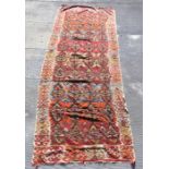 A large kilim rug or wall hanging with repeat design on a beige ground, 365 by 139cms.