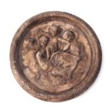 A cast plaster wall plaque decorated with cherubs in relief, 54cms diameter.