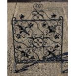 An Arts & Crafts style wrought iron fire guard or spark guard, 52cms wide.