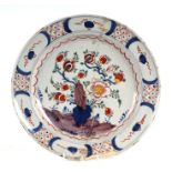 An 18th century Delft polychrome tin glaze pottery plate decorated with flowers, 34cms diameter.