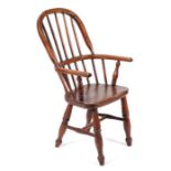 A child's 19th century beech and elm Windsor arm chair with solid seat and ring turned legs joined