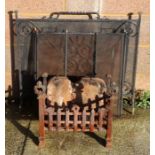 A wrought iron fire basket, 49.5cms wide; and two spark guards (3).