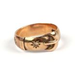 A 9ct gold buckle ring set with two diamonds, approx UK size 'N', 3.7g.