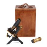 A Victorian lacquered brass monocular microscope, cased; together with a selection of lenses.