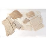 A large quantity of antique lace items to include shawls, veils and edging.