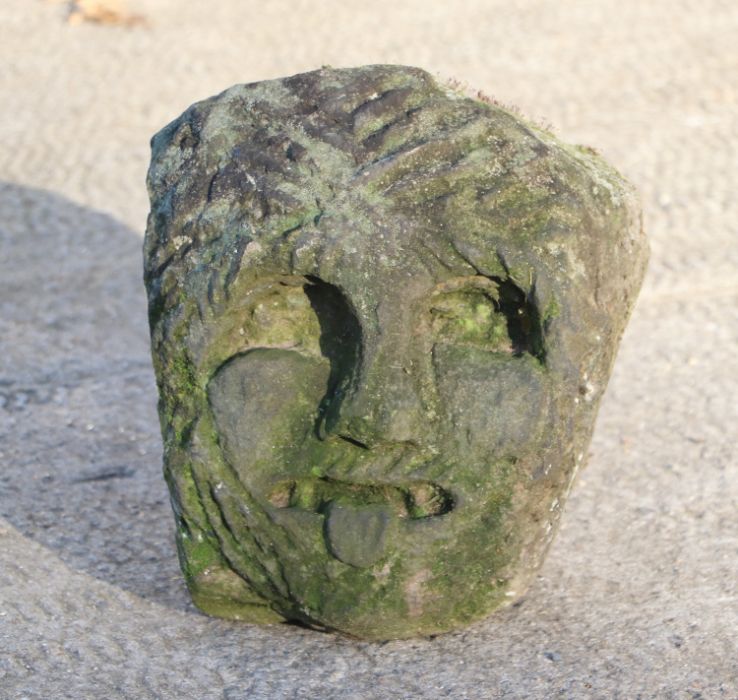 A carved limestone head of a Knights Templar / Green man gargoyle depicted with chain mail cowl