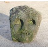 A carved limestone head of a Knights Templar / Green man gargoyle depicted with chain mail cowl