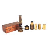 A black lacquer and brass students microscope with a selection of lenses in a mahogany case, 30cms