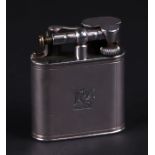 An Alfred Dunhill silver cigarette lighter with armorial and engine turned decoration,