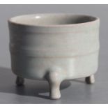 A Chinese pale celadon glaze censer on tripod legs, 7cms diameter.