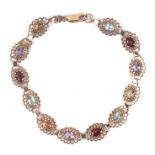 A 9ct gold fancy link bracelet, each link inset with a semi precious stone, total weight 7.2g.
