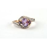 A 10ct gold amethyst and diamond twist cross-over ring, approx UK size 'N', 2.4g.