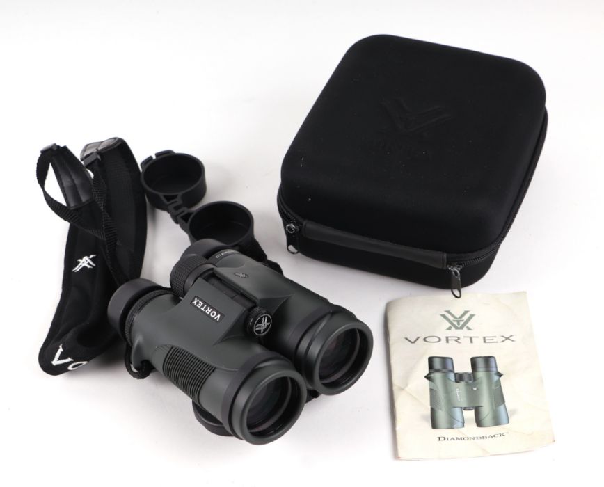 A pair of Vortex diamond black 10x42 binoculars, cased with instruction pamphlet.