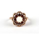 A 9ct gold garnet and opal ring, approx UK size 'N', 3.5g.