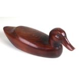 A well carved wooden decoy duck with inset glass eyes, approx 32cms long.