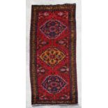 A fine quality Persian hand knotted woollen runner with geometric design within borders, 335 by